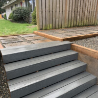 Grey wooden steps leading to a new path New wooden steps
